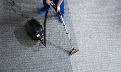 Professional home cleaners sanitizing living room in Brantford.